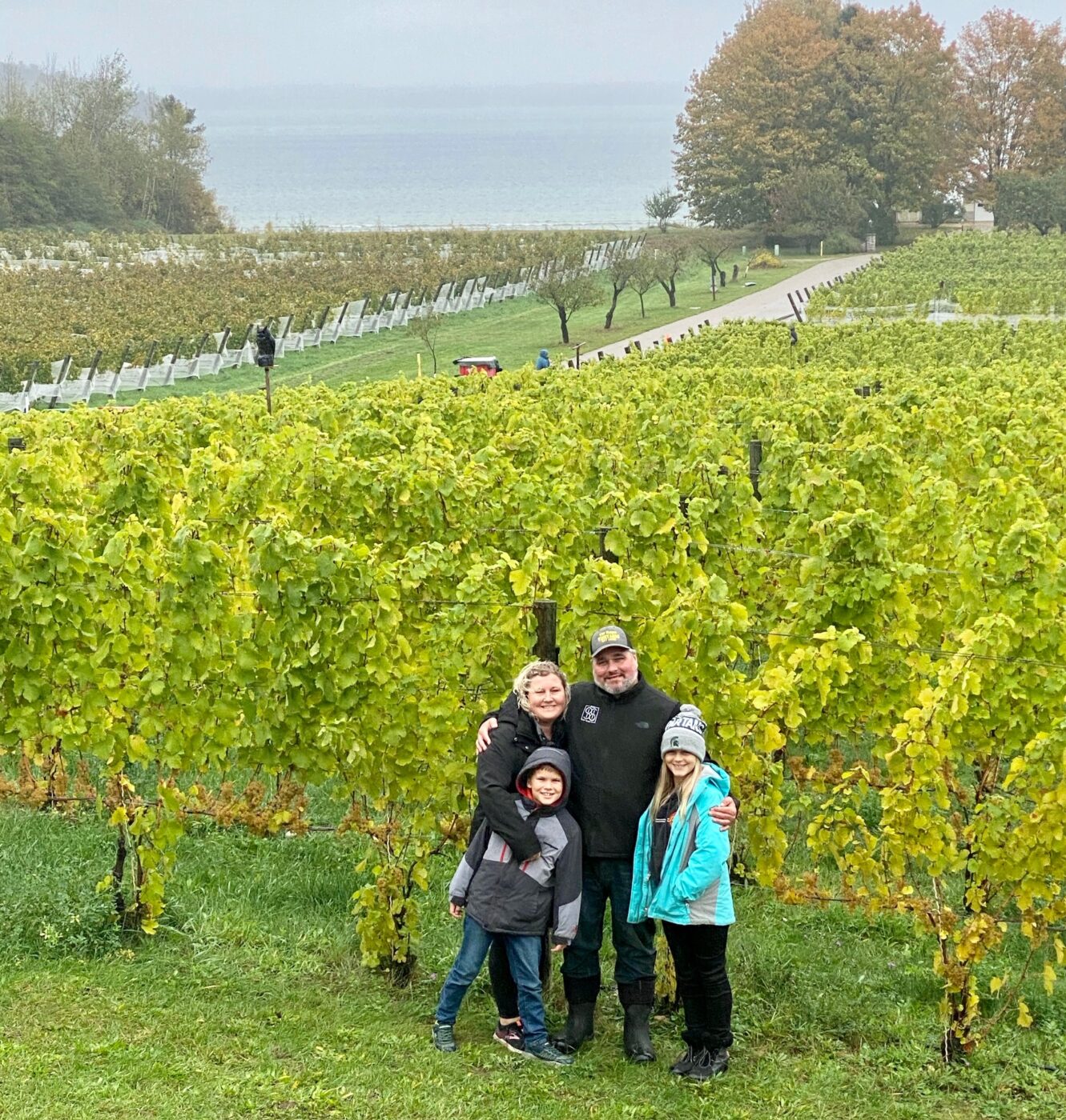 Vineyard workers and family celebrating the 2023 grape harvest at Bos Wine.